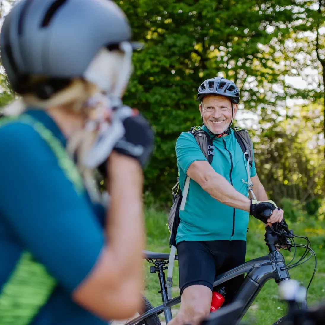 Man and woman riding bicycles in the woods